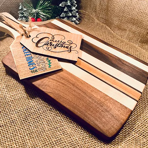 A wooden cutting board with some tags on it