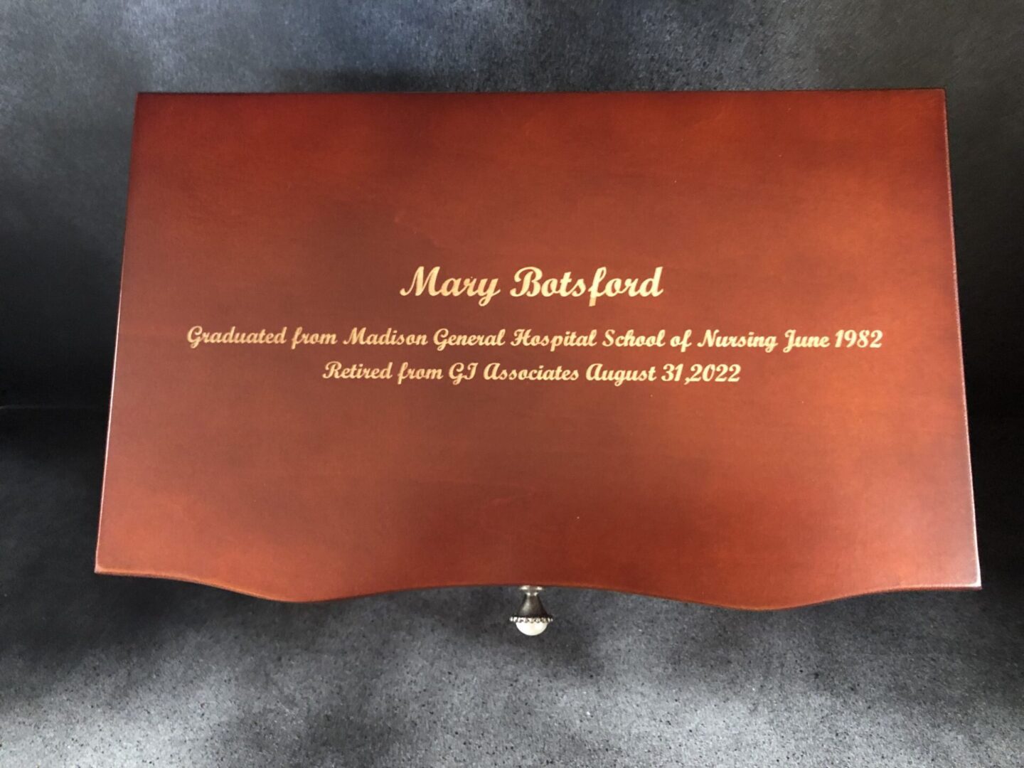 A wooden box with the name of mary bedford engraved on it.